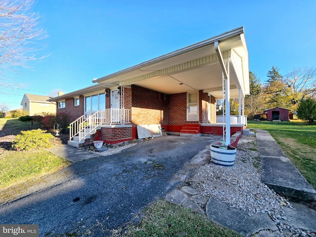 view of front of house with a storage unit