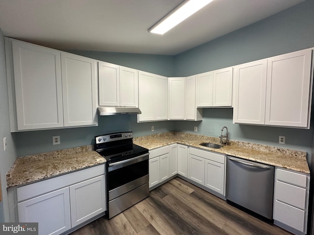 kitchen featuring dark hardwood / wood-style flooring, light stone counters, stainless steel appliances, sink, and white cabinets