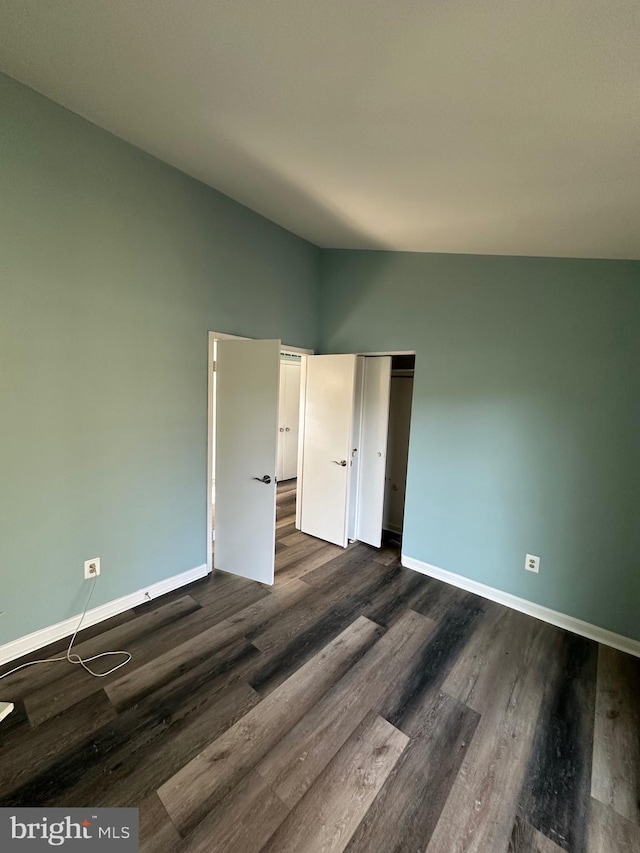 spare room with dark hardwood / wood-style flooring