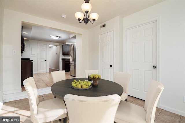 dining area with light tile patterned flooring and baseboards