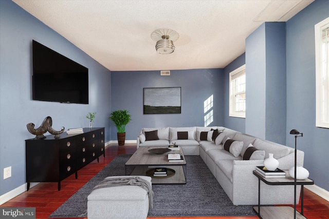 living area with wood finished floors and baseboards