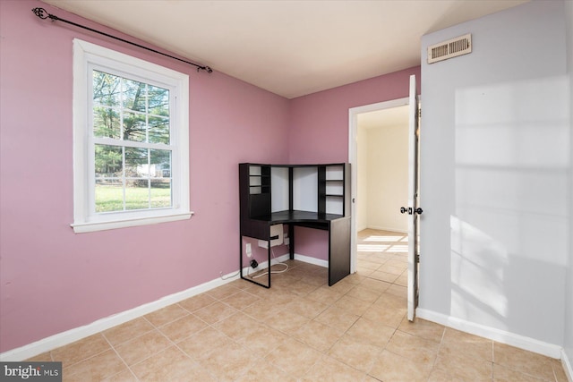 bedroom featuring light tile patterned floors and baseboards