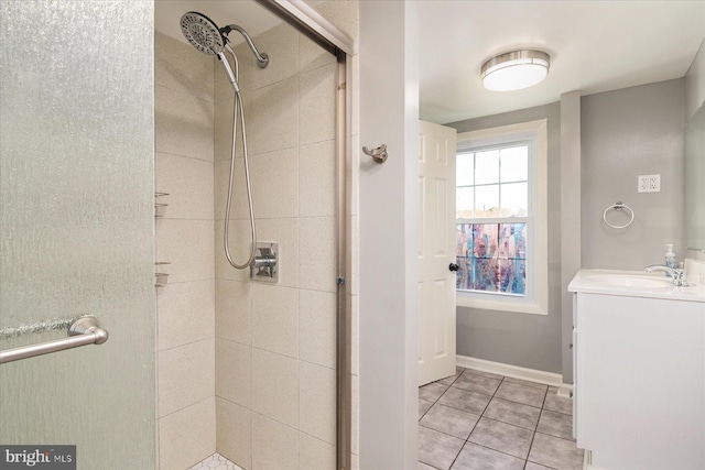 bathroom with tile patterned floors, a shower with door, and vanity