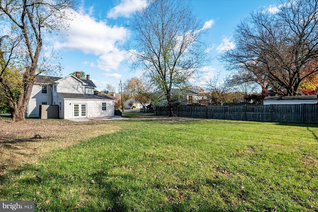 view of yard featuring a patio and french doors