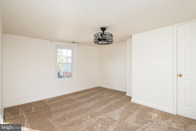 carpeted spare room with baseboards
