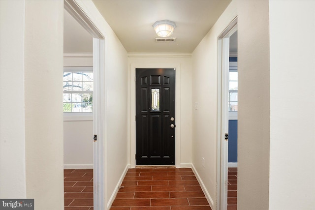 foyer with baseboards and dark wood finished floors