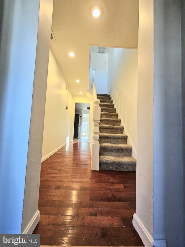 stairs featuring wood-type flooring, recessed lighting, and baseboards