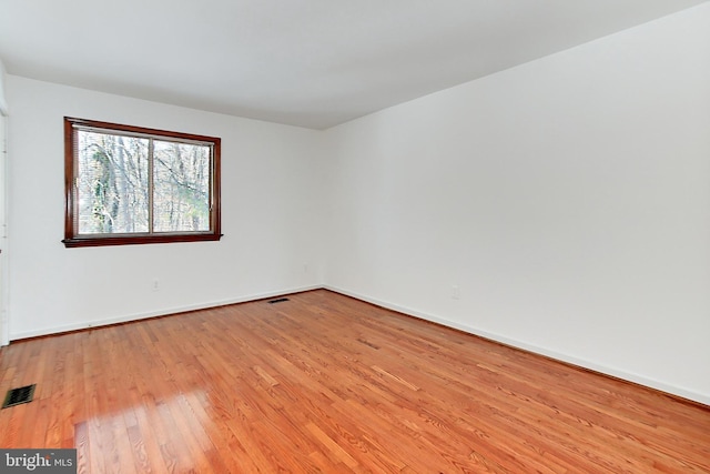 spare room featuring light hardwood / wood-style floors