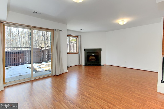 unfurnished living room with light hardwood / wood-style floors