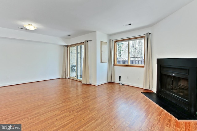 unfurnished living room with light hardwood / wood-style flooring