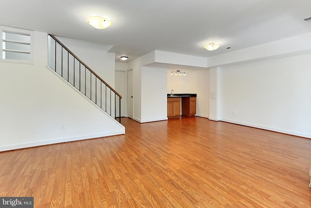 interior space featuring sink and light hardwood / wood-style flooring