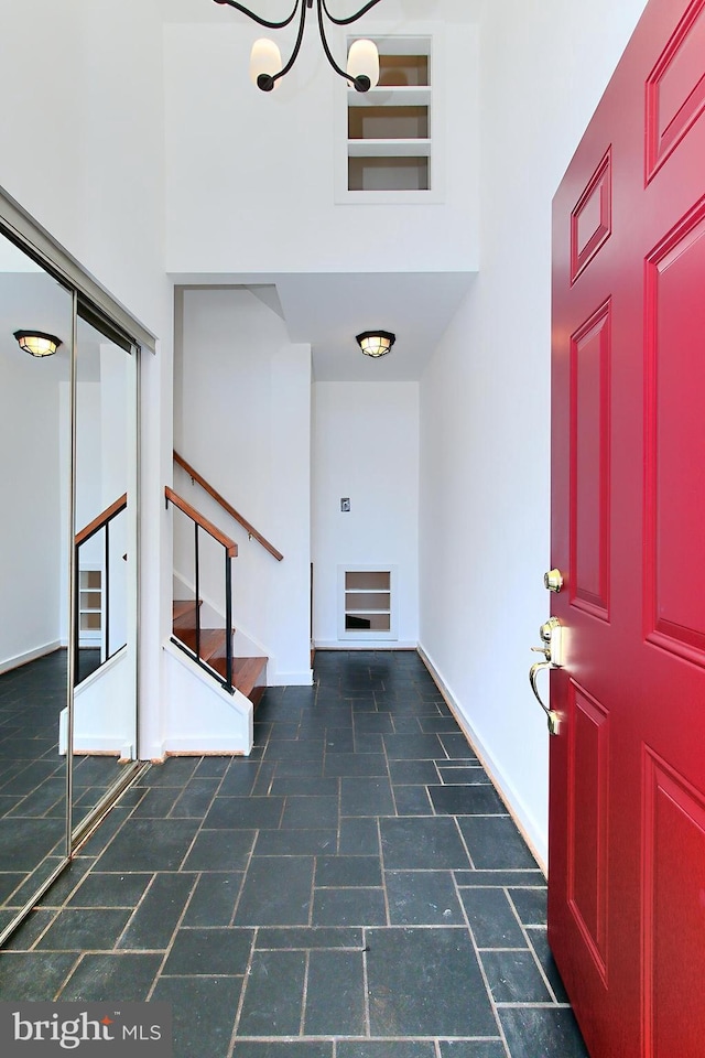 entrance foyer with a towering ceiling and a notable chandelier