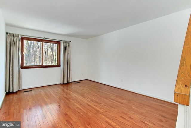 empty room with light hardwood / wood-style floors