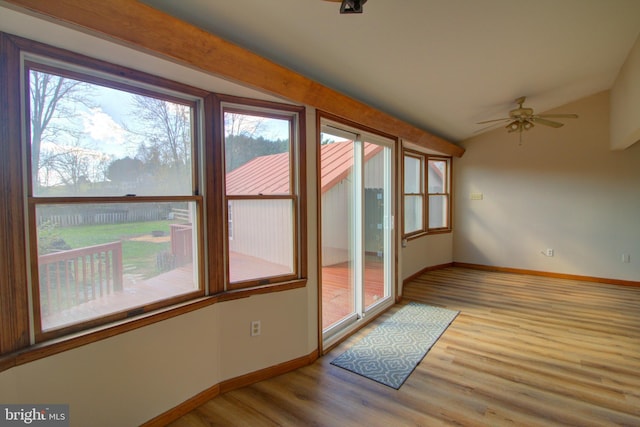 interior space featuring light hardwood / wood-style floors, ceiling fan, and vaulted ceiling