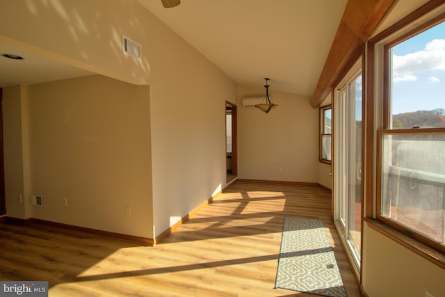 hallway featuring light hardwood / wood-style floors and vaulted ceiling