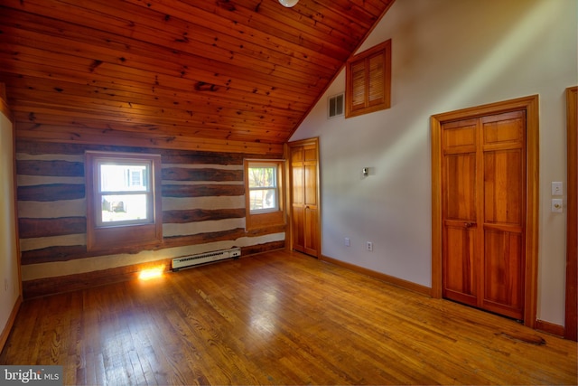 unfurnished living room with hardwood / wood-style floors, wooden ceiling, a healthy amount of sunlight, and a baseboard heating unit