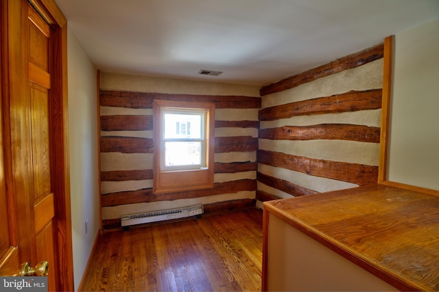 interior space featuring hardwood / wood-style flooring and a baseboard heating unit