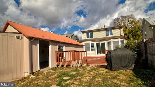 rear view of house with a wooden deck