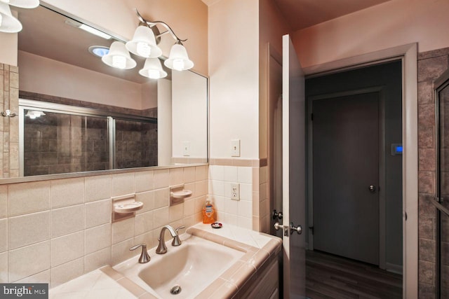 bathroom with vanity, hardwood / wood-style floors, and a shower with shower door