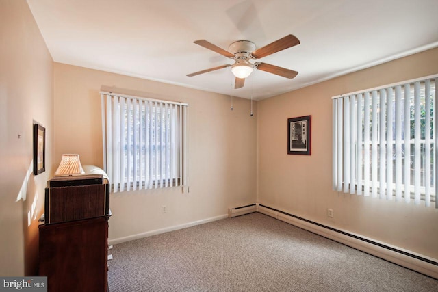 unfurnished bedroom featuring carpet flooring, a baseboard radiator, multiple windows, and ceiling fan