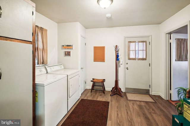 laundry room with dark wood-type flooring and independent washer and dryer