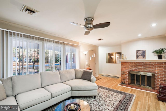 8388 Hilda Dr, Salisbury, MD 21804 - living area featuring ceiling fan, ornamental molding, wood finished floors, a brick fireplace, and baseboards