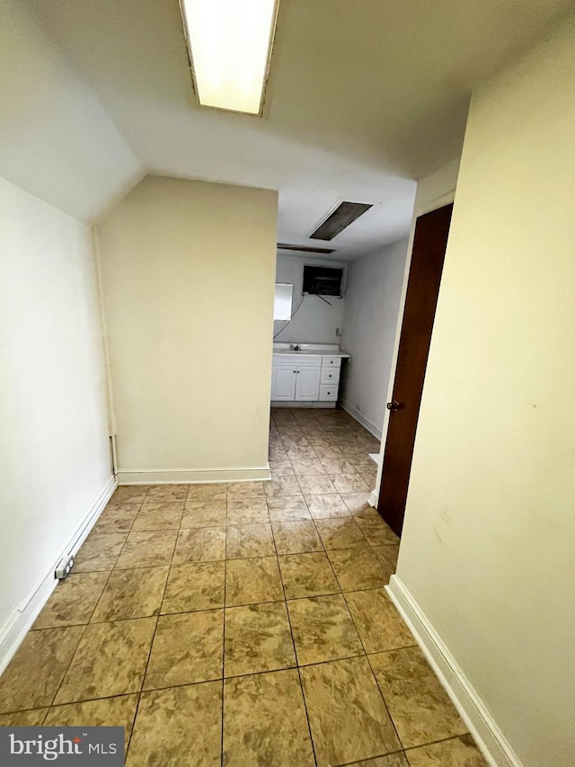 hallway featuring vaulted ceiling