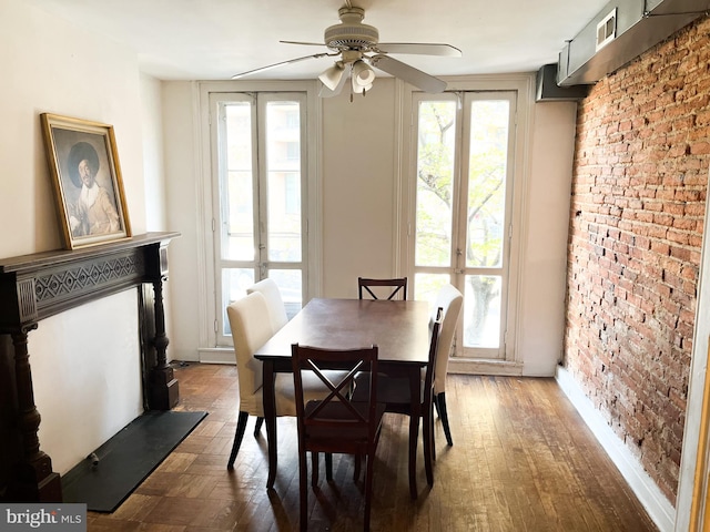 dining room with ceiling fan, brick wall, and french doors