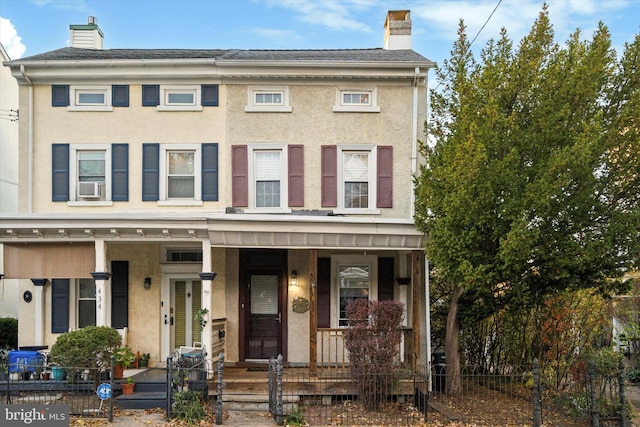 view of front of house featuring a porch and cooling unit