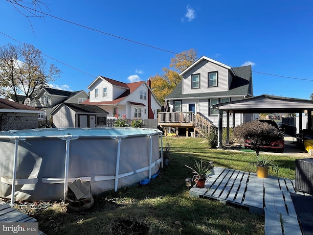 back of house featuring a lawn and a pool side deck