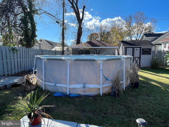 view of pool with a lawn