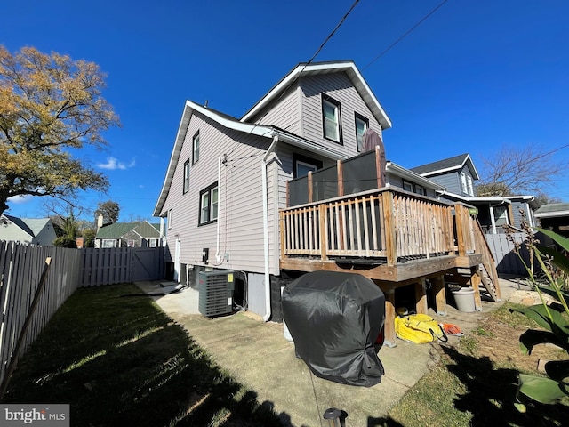 back of house featuring a deck and central air condition unit