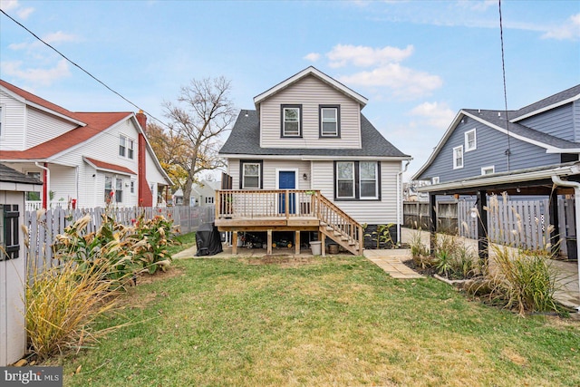 rear view of property with a yard and a deck