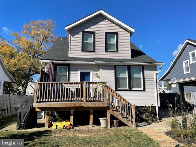 rear view of property featuring a wooden deck