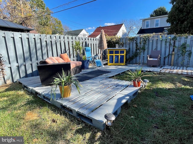 wooden deck featuring an outdoor hangout area and a lawn