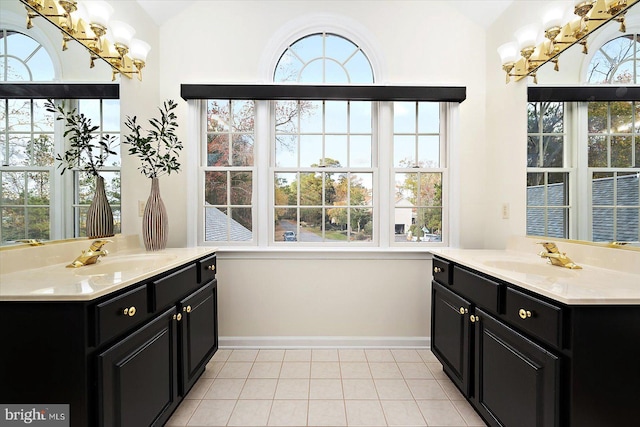 bathroom featuring tile patterned flooring, vanity, and vaulted ceiling