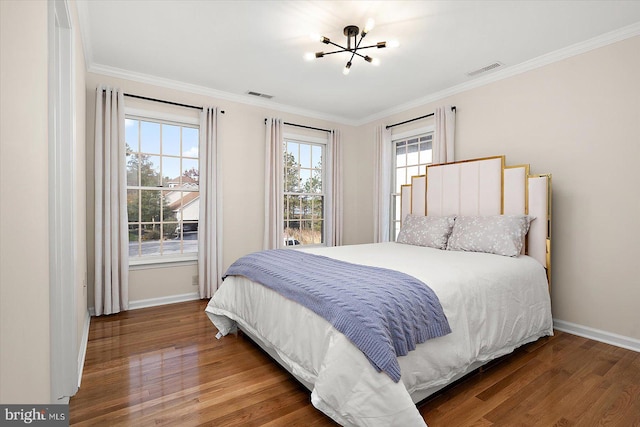 bedroom featuring crown molding, dark wood-type flooring, and multiple windows