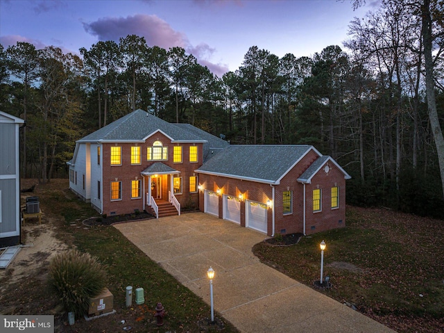 view of front facade featuring a garage and central AC