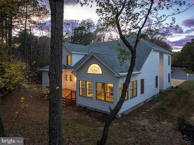 view of back house at dusk