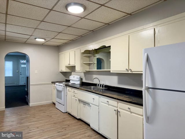 kitchen with sink, white cabinets, white appliances, and light wood-type flooring