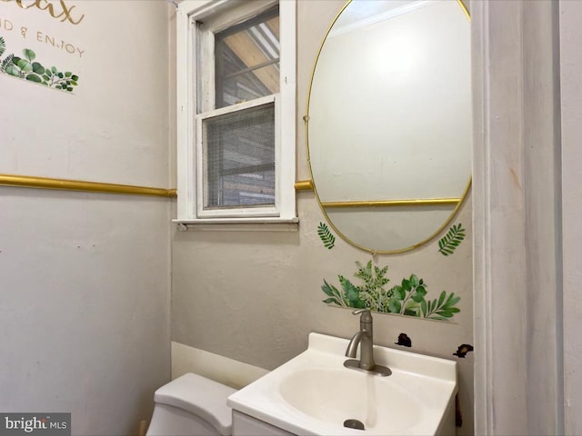 bathroom featuring vanity and toilet