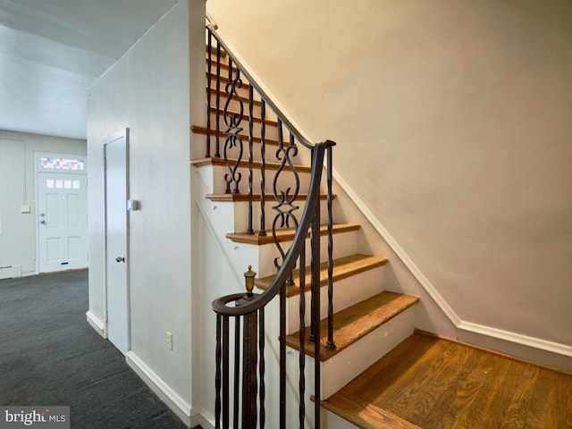 staircase featuring carpet floors and a baseboard radiator