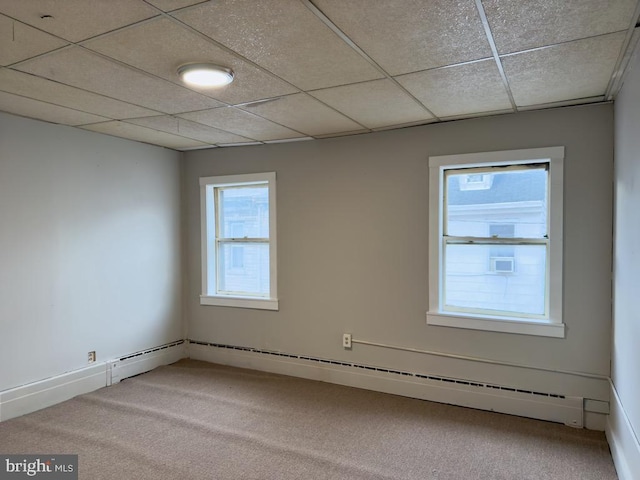 unfurnished room featuring carpet flooring and a drop ceiling