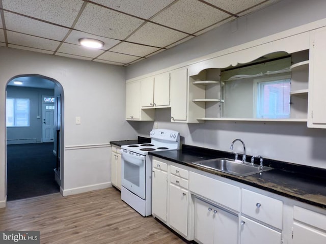 kitchen with a drop ceiling, white electric range oven, a baseboard heating unit, sink, and white cabinets