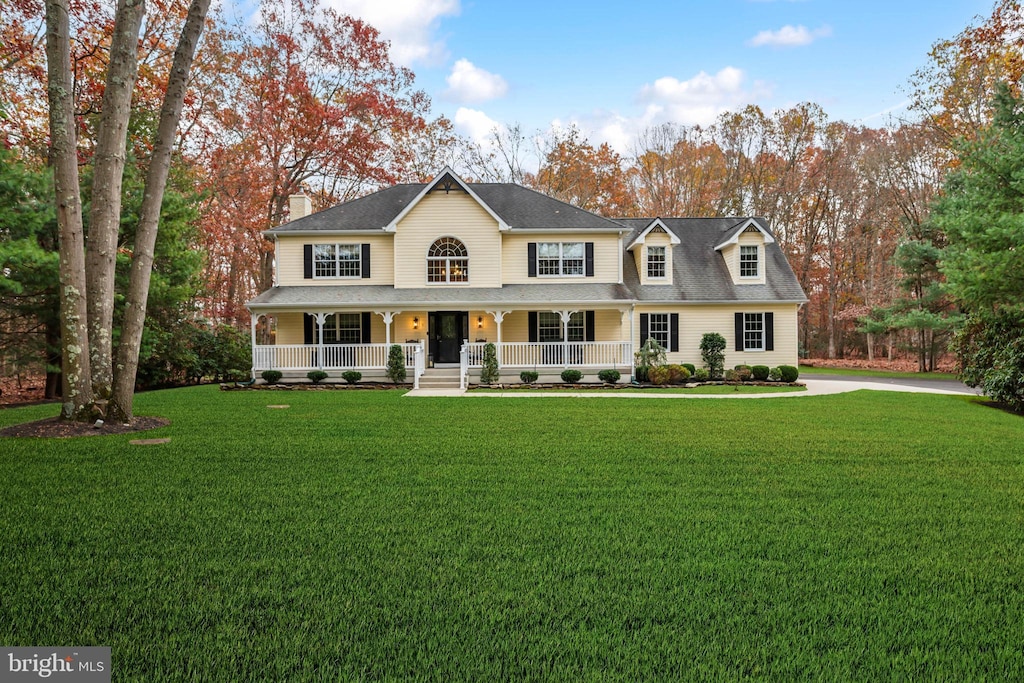 view of front of home with a porch and a front lawn