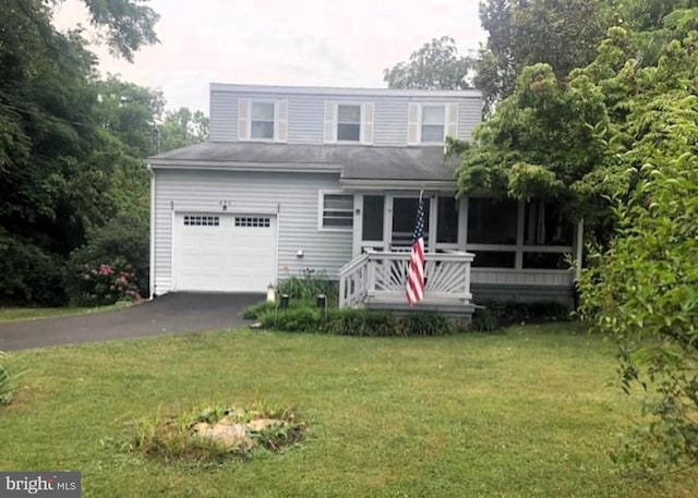 view of front of property with a front yard and a garage