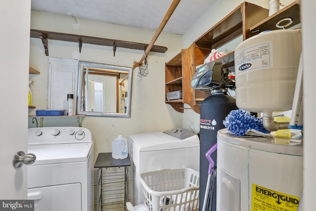 laundry area featuring washing machine and dryer and electric water heater