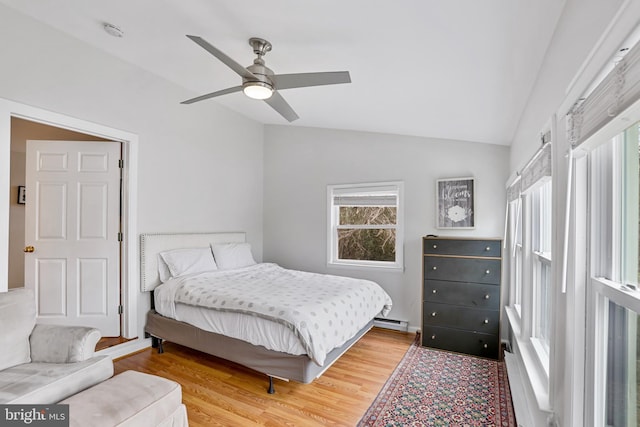 bedroom with baseboard heating, ceiling fan, wood-type flooring, and lofted ceiling