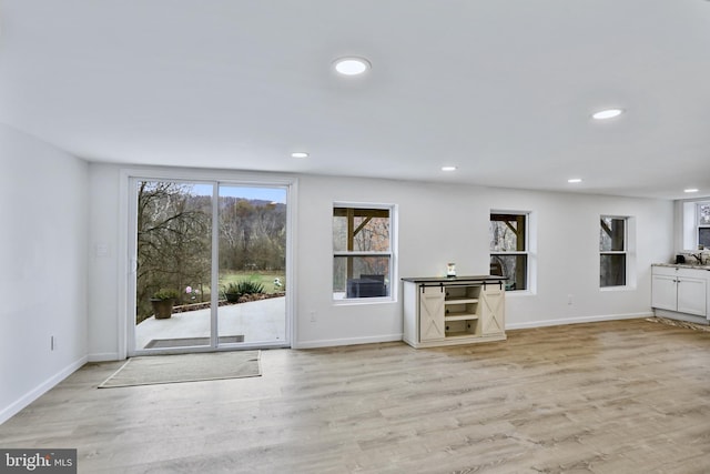 unfurnished living room featuring light hardwood / wood-style flooring