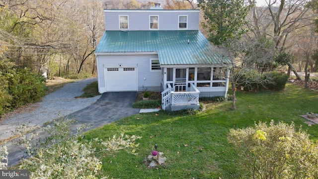 view of front of property with a sunroom and a front lawn